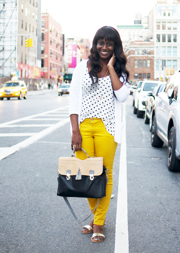 long black wavy hair, polka dot top, white cardigan, wavy hair with bangs, yellow jeans, outfit with yellow jeans